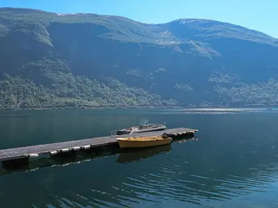 a boat is docked at a dock in the water at Holiday Home Jambueggi by Interhome in Arnefjord