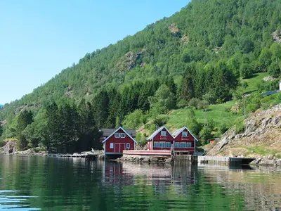 a group of houses on the water near a mountain at Holiday Home Jambueggi by Interhome in Arnefjord