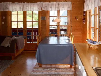 a dining room with a long table in a cabin at Holiday Home Jambueggi by Interhome in Arnefjord