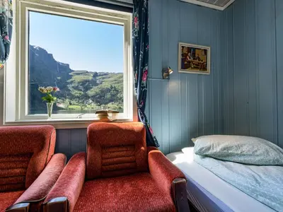 a train room with two chairs and a window at Holiday Home Indresfjord by Interhome in Åse