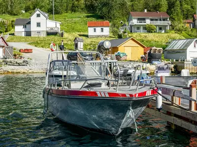 a boat is docked at a dock in the water at Holiday Home Indresfjord by Interhome in Åse