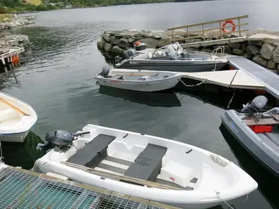 two boats are docked at a dock in the water at Holiday Home Nanna by Interhome in Hyllestad