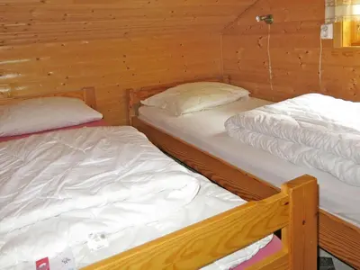 two bunk beds in a room with wooden walls at Holiday Home Idun by Interhome in Hyllestad