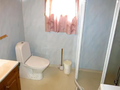 a small bathroom with a toilet and a shower at Holiday Home Idun by Interhome in Hyllestad
