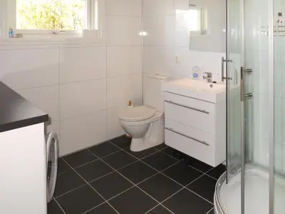 a bathroom with a toilet and a sink and a shower at Holiday Home Hjartnesvika by Interhome in Hjartåker