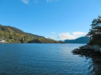 a large body of water with mountains in the background at Holiday Home Hjartnesvika by Interhome in Hjartåker