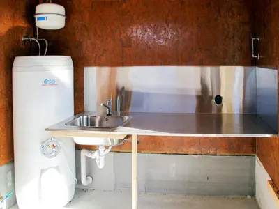 a kitchen with a sink next to a refrigerator at Apartment Huglavika by Interhome in Nordhuglo