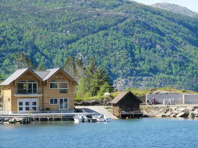 a house on a dock on a lake at Apartment Huglavika by Interhome in Nordhuglo