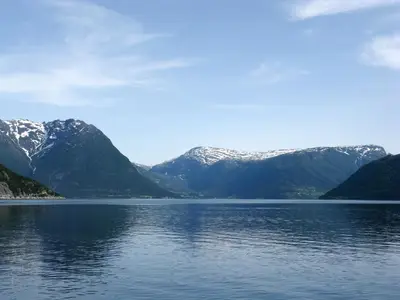 a view of a lake with snow covered mountains at Chalet Slåttenes by Interhome in Naustflot