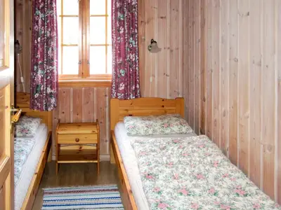 a bedroom with two beds and a window at Chalet Slåttenes by Interhome in Naustflot