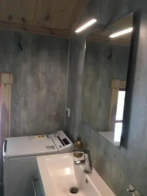 a bathroom with a white sink and a mirror at Nilsrud 30 Feriehus in Åmotsdal