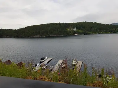 a group of boats sitting on the side of a lake at Villa Oleanna in Lysekloster