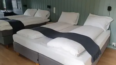 a room with three beds with white pillows on them at Villa Oleanna in Lysekloster