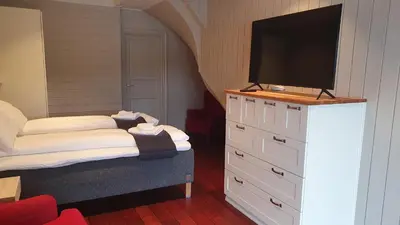 a bedroom with a dresser with a flat screen tv on it at Villa Oleanna in Lysekloster