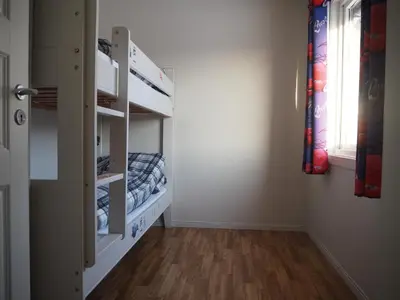 a room with a hallway with a bunk bed at Cabin with great view close to town and ski area in Lillehammer