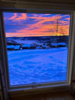 a window with a view of a winter sunset at Cabin with great view close to town and ski area in Lillehammer