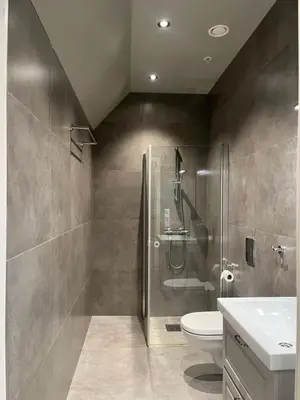 a bathroom with a shower and a toilet and a sink at Nygårdsgaten apartments in Bergen