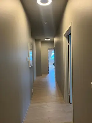 a hallway of a house with a hallway leading to a door at Nygårdsgaten apartments in Bergen