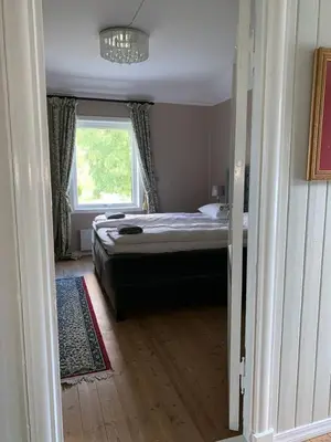 a small bedroom with a bed and a window at Moldegaard Farmhouse - Apartment B in Moldegard