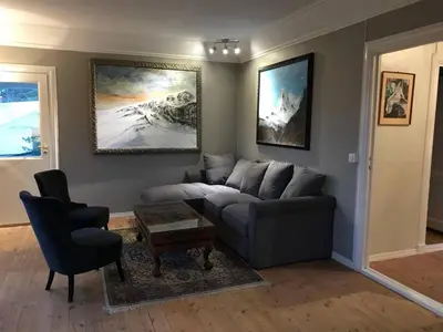 a living room with a couch and a chair at Moldegaard Farmhouse - Apartment B in Moldegard