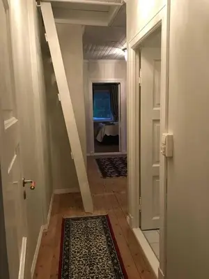 a hallway with a door and a room with a rug at Moldegaard Farmhouse - Apartment B in Moldegard