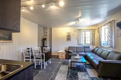 a living room with a couch and a table at Røde Kors ground floor in Brunstad