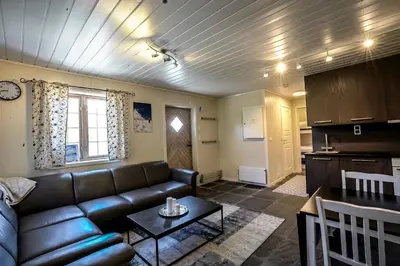 a living room with a couch and a table at Røde Kors ground floor in Brunstad