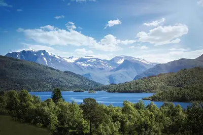 a view of a lake with mountains in the background at Røde Kors ground floor in Brunstad