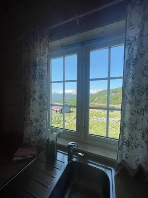 a kitchen sink and a window with a view at Bjørgo Gard - Stegastein in Aurland