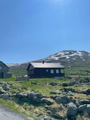 a black house on the side of a hill at Bjørgo Gard - Stegastein in Aurland