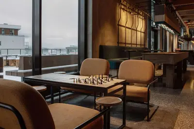 a room with a chessboard on a table and chairs at Scandic Voss in Vossevangen