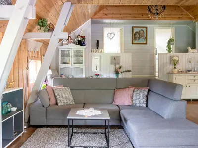 a living room with a couch and a table at Holiday Home Rødehuset by Interhome in Gjelland