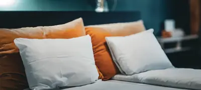 a couch with two pillows on top of it at Hotell Molde in Molde