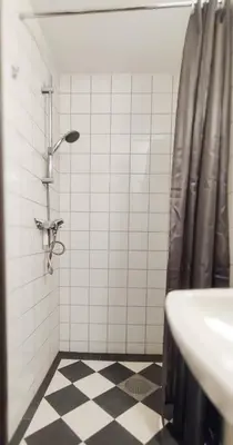 a bathroom with a shower and a sink at Hotell Molde in Molde