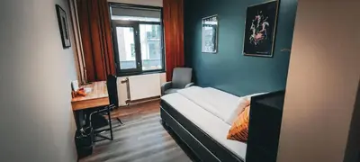 a small room with a bed and a window at Hotell Molde in Molde