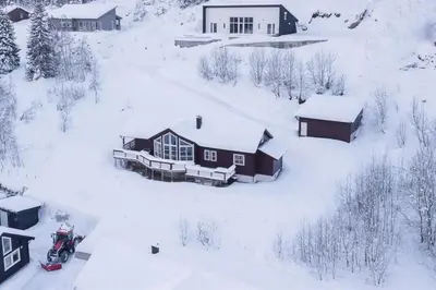 an aerial view of a house covered in snow at Cabin in Hodlekve with 5 bedrooms & hot tub. in Sogndal