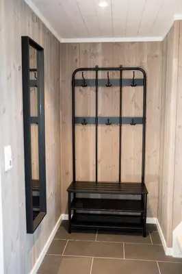 a dressing room with a bench and a mirror at Furetoppen Panorama in Stryn