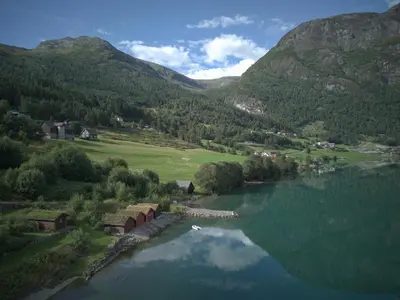 an aerial view of a lake in a valley with mountains at Furetoppen Panorama in Stryn