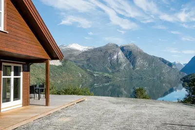 a house with a view of mountains and a lake at Furetoppen Panorama in Stryn