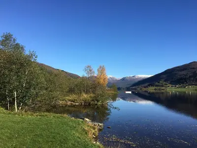 a view of a river with mountains in the background at Voss- Oppheim suite private cozy cabin in Vossestrand