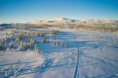 an aerial view of a snow covered field with trees at Spåtind Fjellhotell in Nord Torpa
