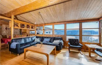 a living room with a couch and a table at Awesome Home In Vatne With Wifi in Vatne