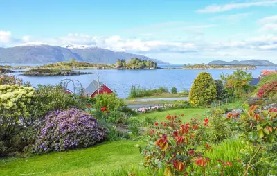 a garden with a view of a body of water at 1 Bedroom Lovely Apartment In Svortevik in Svortevik