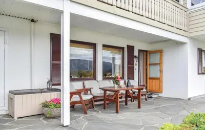 a patio with a wooden table and chairs at 1 Bedroom Lovely Apartment In Svortevik in Svortevik