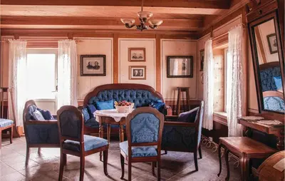 a living room with a blue couch and a table at Beautiful Home In Tynset With Kitchen in Tynset