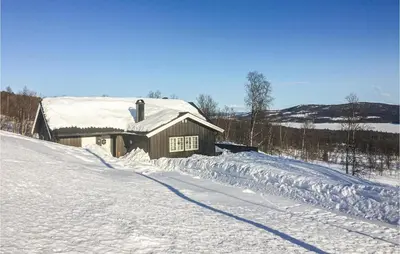 a house is covered in snow with a road at Stunning Home In Hemsedal With Kitchen in Hemsedal