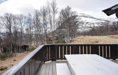 a wooden deck with a bench on top of a mountain at Stunning Home In Hemsedal With Kitchen in Hemsedal