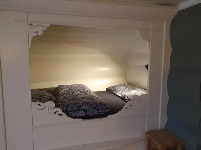 a small bedroom with two beds in a cabinet at Kvambekk Gard i Åmotsdal in Åmotsdal