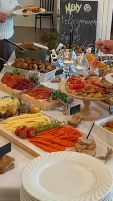 a buffet with many different types of food on a table at Eidsvåg Fjordhotell in Eidsvåg