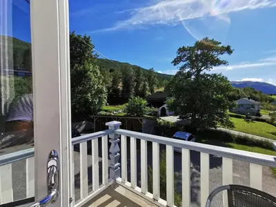 a balcony with a view of the mountains at Eidsvåg Fjordhotell in Eidsvåg